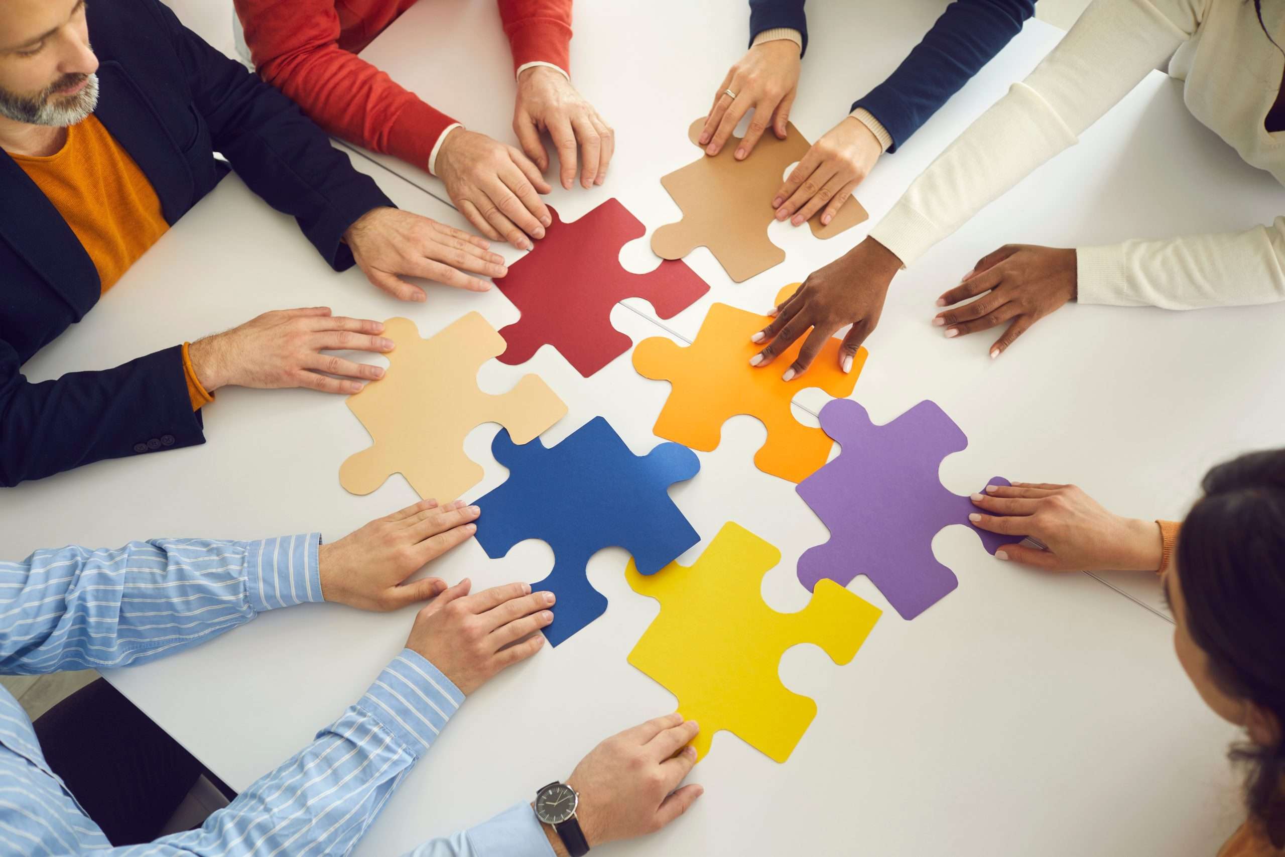 team putting together a colorful puzzle