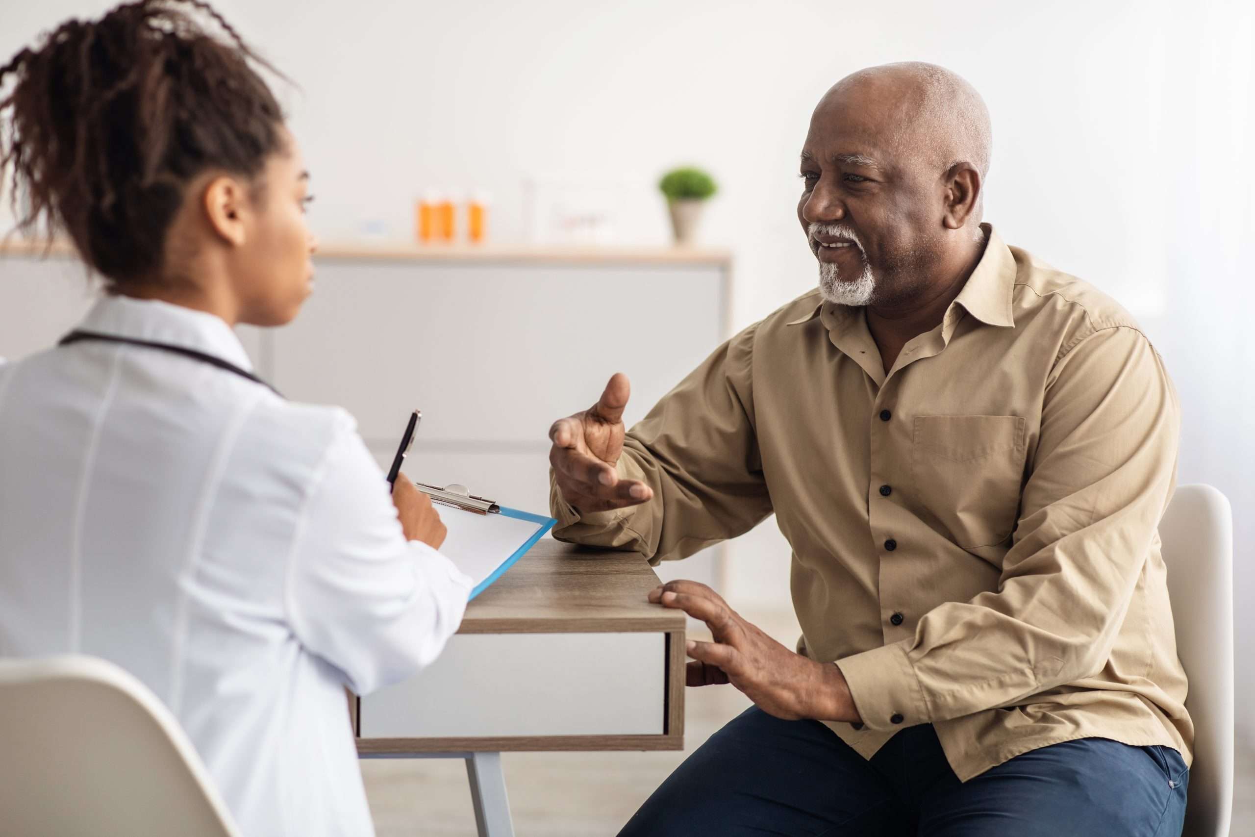 a doctor talking with an older patient